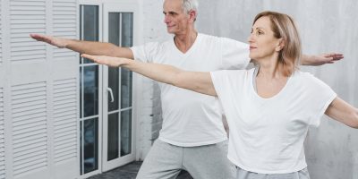 healthy-couple-performing-exercising-yoga-mat-home